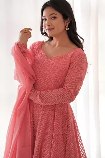 Charming pink anarkali suit with all-over embroidery, ruffled net dupatta, and matching pants   ideal for festive looks.