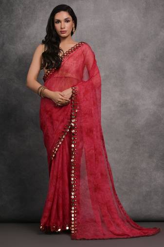 Pink printed georgette saree with mirror work border