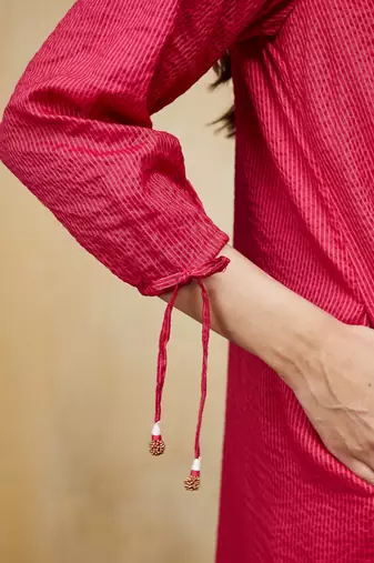 Pink plain cotton stripe kurti with tassel details.