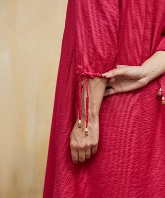 Pink plain cotton stripe kurti with tassel details. 4