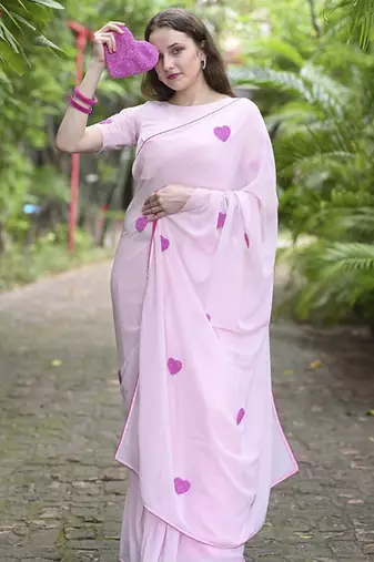 Pink plain georgette saree featuring heart motifs
