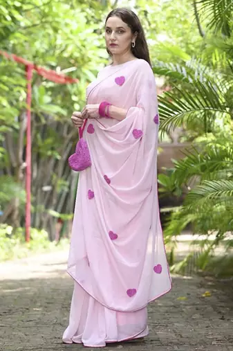 Pink plain georgette saree featuring heart motifs