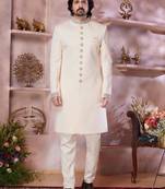 Cream imported plain fabric sherwani with faux satin churidar foe men