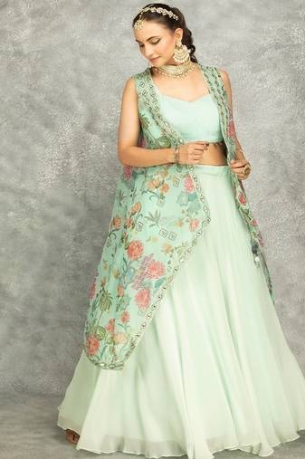 Turquoise lehenga with embroidered cape and crop top bustier