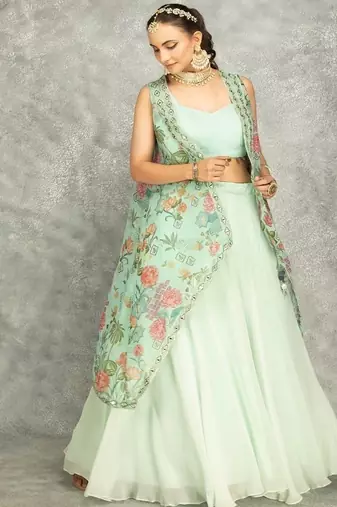 Turquoise lehenga with embroidered cape and crop top bustier