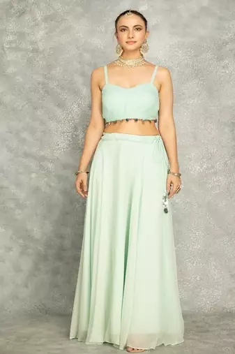 Turquoise lehenga with embroidered cape and crop top bustier