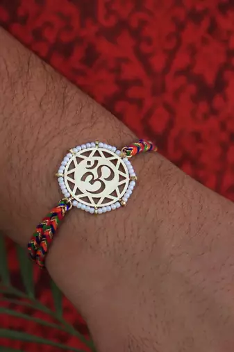 golden beaded om rakhi with roli chawal