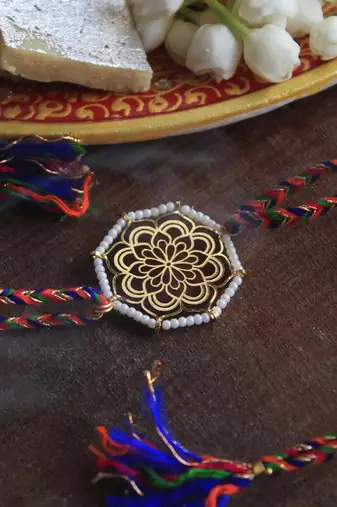 Golden beaded mandala rakhi with roli chawal