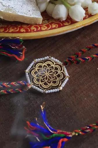 Golden beaded mandala rakhi with roli chawal