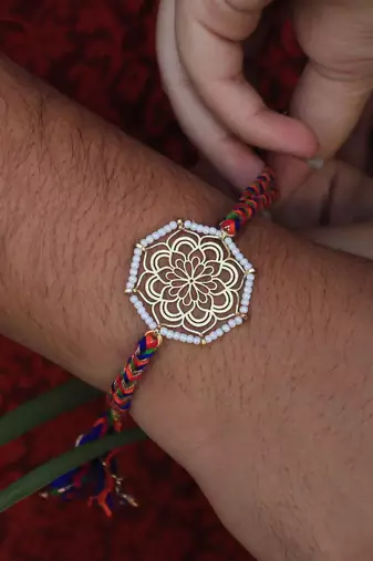 Golden beaded mandala rakhi with roli chawal