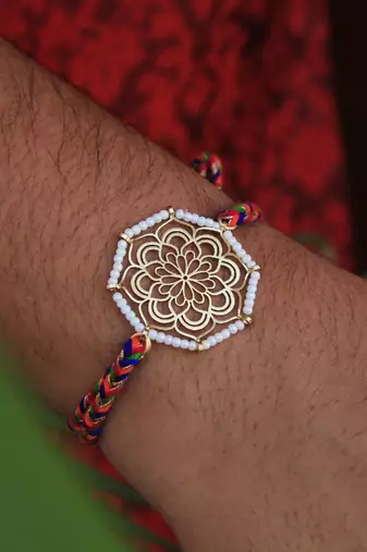 Golden beaded mandala rakhi with roli chawal
