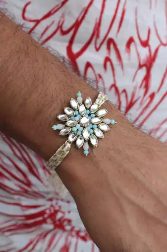 Blossoming kundan and bead work rakhi with roli chawal