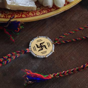 Golden beaded swastik rakhi with roli chawal 2