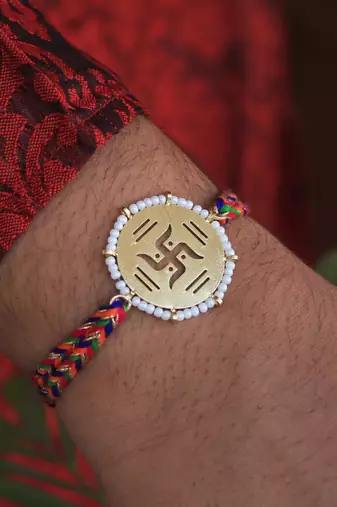Golden beaded swastik rakhi with roli chawal