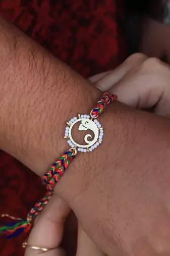 Golden beaded divinity rakhi with roli chawal