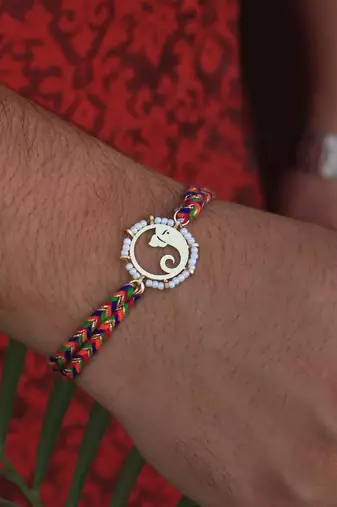 Golden beaded divinity rakhi with roli chawal