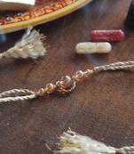Gleaming beads rakhi with roli chawal