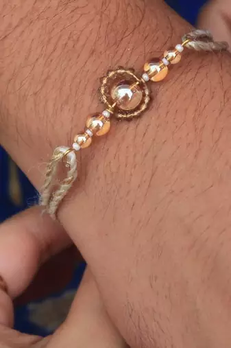 Gleaming beads rakhi with roli chawal