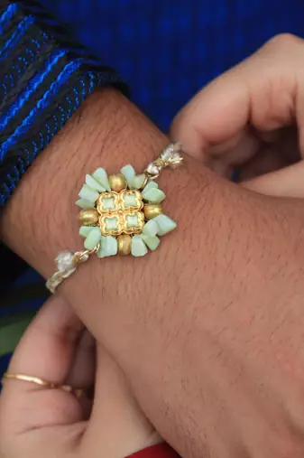Lush green rakhi with roli chawal
