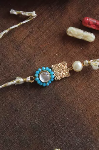 Skyey kundan pearl rakhi with roli chawal