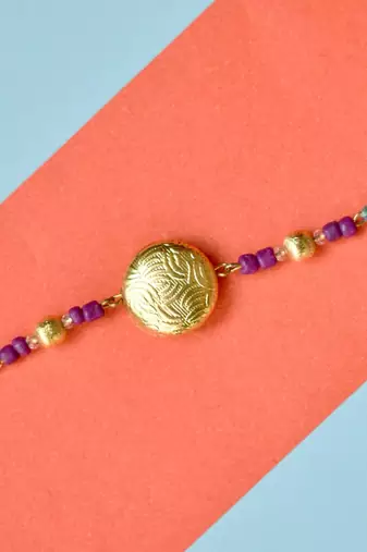 Golden crescent rakhi with roli chawal