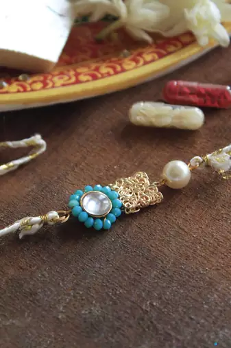 Skyey kundan pearl rakhi with roli chawal