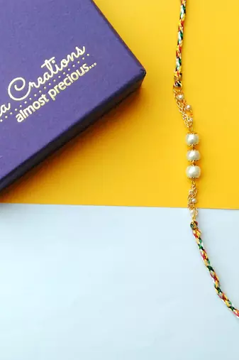 Pearly rakhi with roli chawal