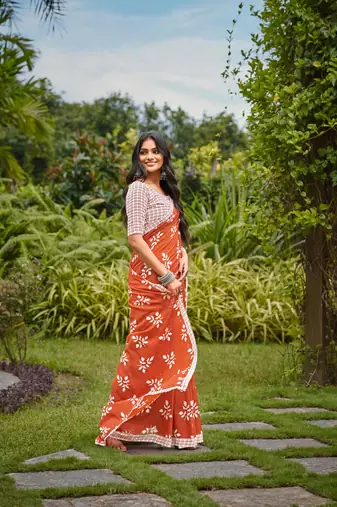Orange cotton floral print saree with printed blouse piece