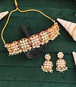 Elegant gold plated kundan choker necklace set with floral motifs, pearls, and matching earrings
