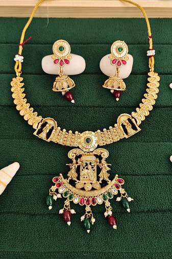 Temple jewellery rajwadi polish short necklace set with fancy design, red & green stones, and jhumka earrings.