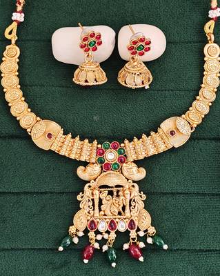 South indian jewelry necklace set with lakshmi pendant, ruby & green stones, coin design, and matching jhumka earrings 1
