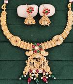 South indian jewelry necklace set with lakshmi pendant, ruby & green stones, coin design, and matching jhumka earrings