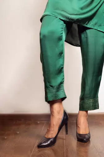 Green asymmetric modal silk kurta set with ajrakh yoke detailing