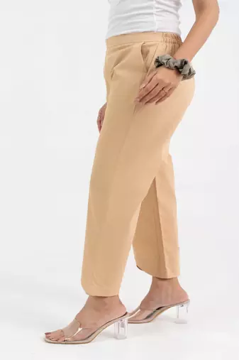 Beige cotton  solid pant with leaf bottom