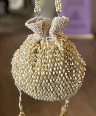 Adara ivory suede potli with pearl gold hanging 2