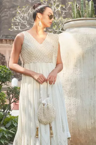 Adara ivory suede potli with pearl gold hanging
