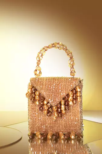 Semi velvet  suede based gold handbag with crystal bead work