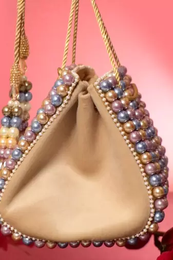 Multicolour suede based handbag adorned with intricate beadwork pearls