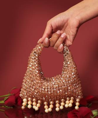 Gold potli bag with crystal work and pearl hangings 1