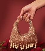 Gold potli bag with crystal work and pearl hangings