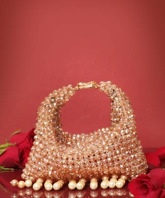 Gold potli bag with crystal work and pearl hangings 2