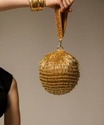 Gold handcrafted semi suede handbag 1