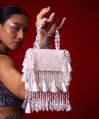 White suede embroidered handbag with flowy detailing 1