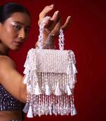 White suede embroidered handbag with flowy detailing