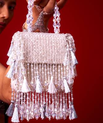 White suede embroidered handbag with flowy detailing 2