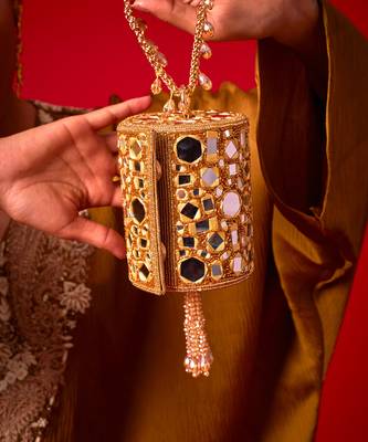 Gold satin potli bag adorned with mirror detailing 2