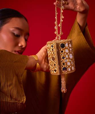 Gold satin potli bag adorned with mirror detailing 3