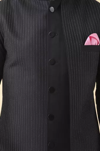 Black solid silk bandhgala jacket paired with kurta & pant