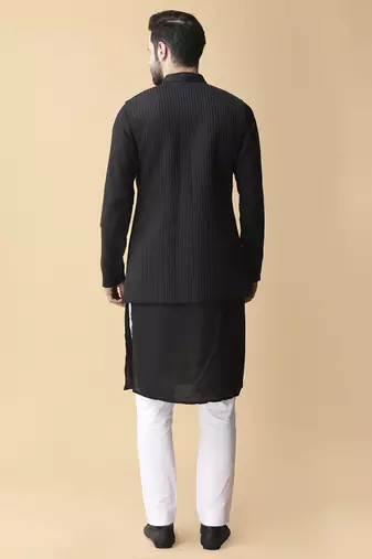 Black solid silk bandhgala jacket paired with kurta & pant