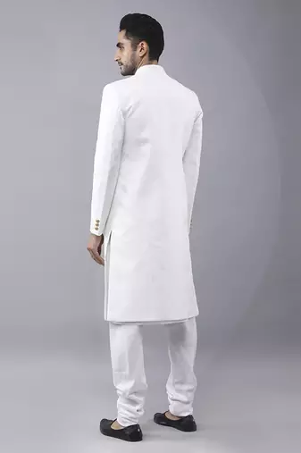 White brocade solid sherwani paired with kurta & churidaar